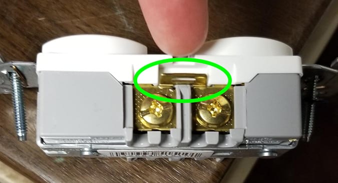 If you break this, each side of the outlet can be controlled independently. Don't break the tab on the other (neutral) side.